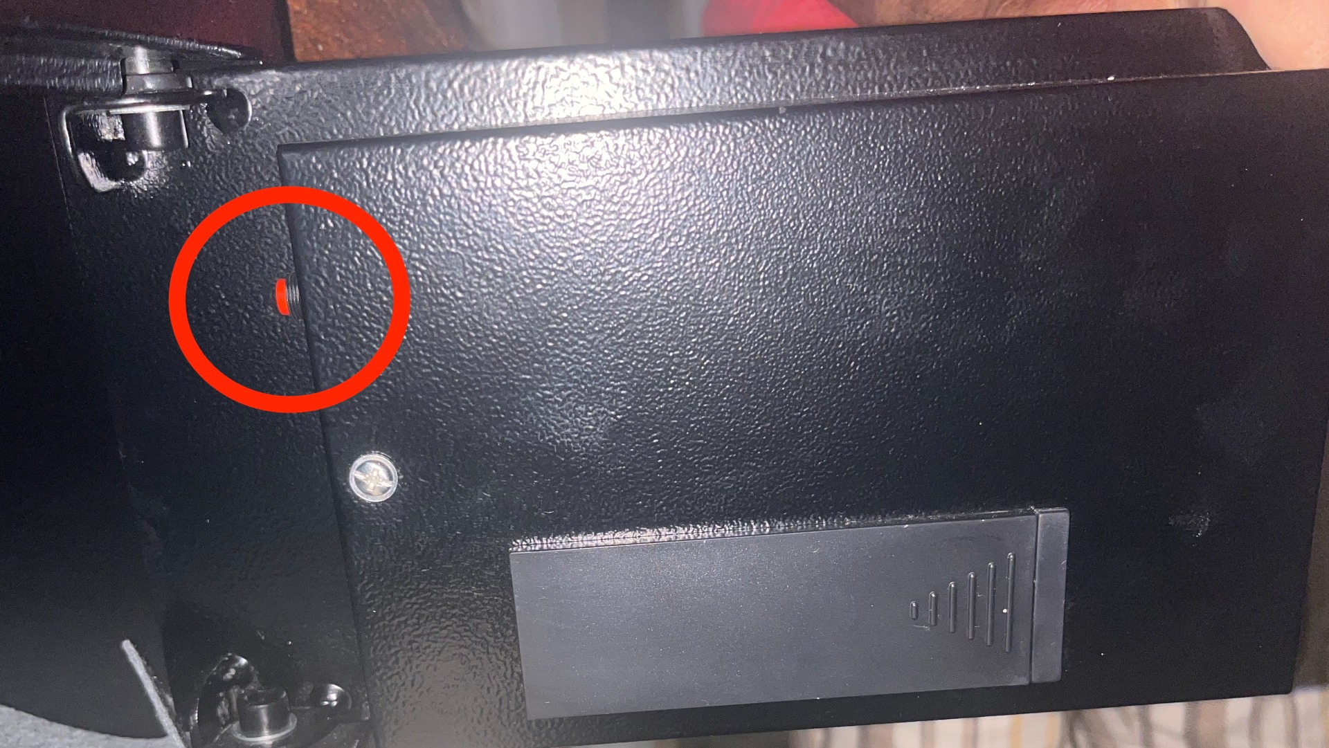 Safe door from the inside with the red reset button highlighted in the red circle